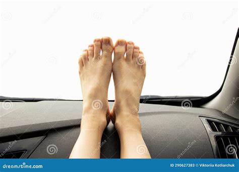 Womenand X27s Bare Feet Lie On The Dashboard Of A Car On A White