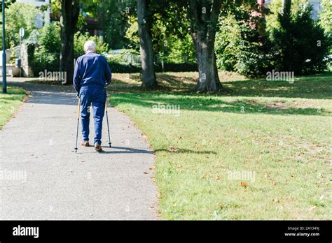 older man walking  canes   park stock photo alamy