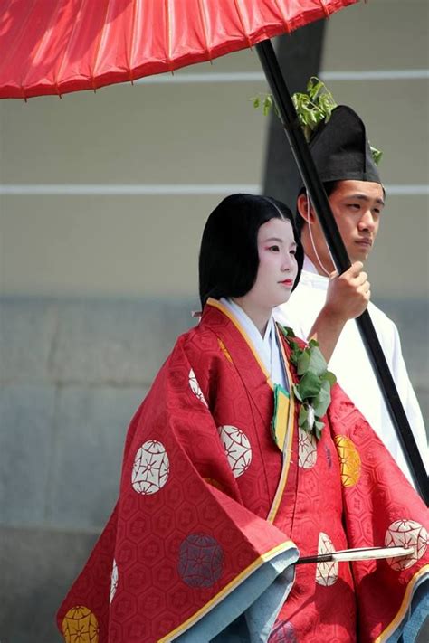 A Man And Woman Dressed In Heian Robes For The Aoi Festival Japanese