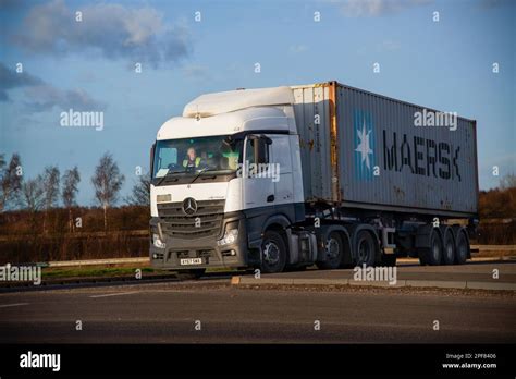 A Mercedes Benz Actros Truck Pulling A Trailer With A Maersk Shipping