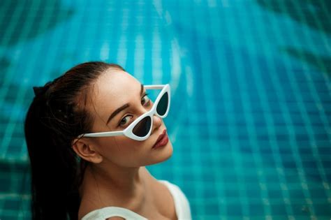 Premium Photo High Angle Portrait Of Young Woman Wearing Sunglasses In Swimming Pool