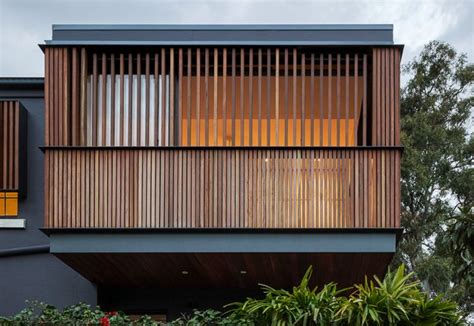 The House Is Made Out Of Wood And Has Vertical Slats On The Facade