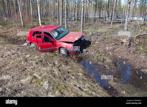 Crashed Red Vw Volkswagen Golf Laying At Roadside Ditch Finland Stock