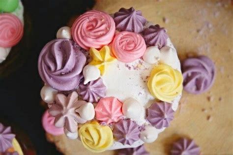 Some Cupcakes With Frosting And Flowers On Them