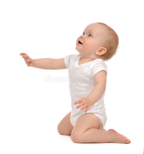 Infant Baby Toddler Sitting Hand Pointing And Looking Up Stock Image