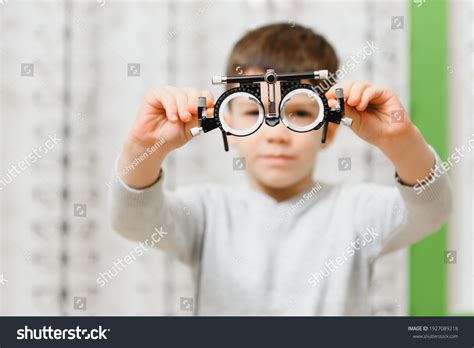 child boy showing trial frame ophthalmology stock photo