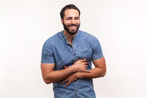 Premium Photo Positive Bearded Man Holding His Belly And Laughing Out