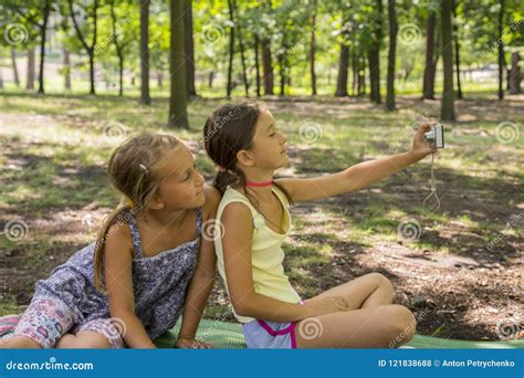 Two Girls Taking A Photo In The Park The Girls In The Park Make