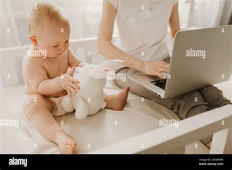 Close Up Portrait Of Little Boy Sitting On Mothers Lap And Studying