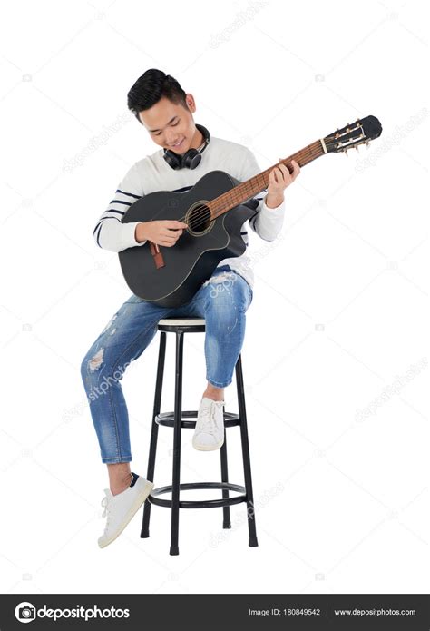 Acoustic Guitarist On Stool