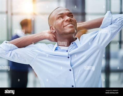 Happy African American Young Businessman Holding Hands Behind Head