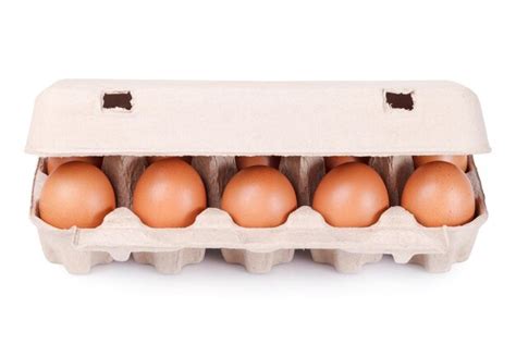 Premium Photo | Ten brown eggs in a carton package