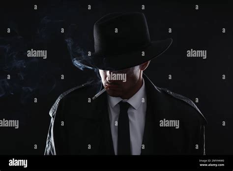 Old Fashioned Detective Smoking Cigarette On Dark Background Stock