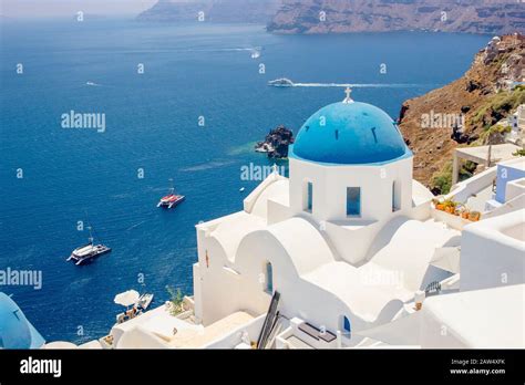 Famous Blue Dome Orthodox Church In Village Of Oia On Santorini Island