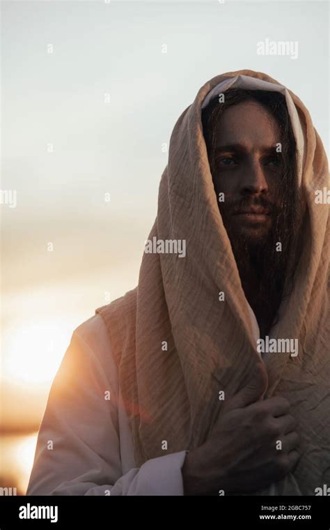 Portrait Of Jesus Christ In His Traditional White Robe Against Sunset