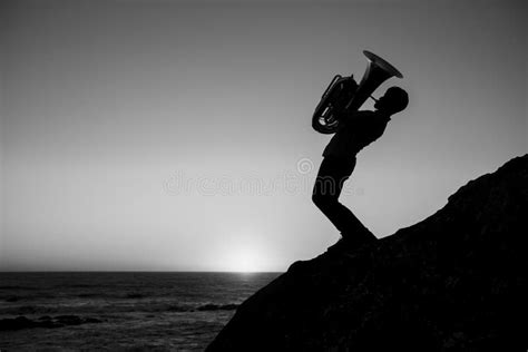 Silhouette of a Musician with a Tuba on the Seashore. Black and White ...