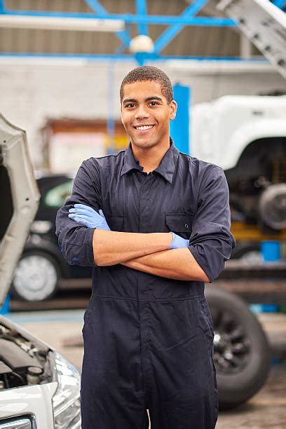 Car Mechanic Standing With Arms Crossed Stock Photos Pictures