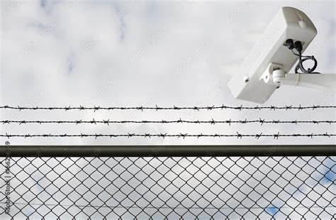 Cctv Camera Monitoring At Prison Security Camera Behind Barbed Wire