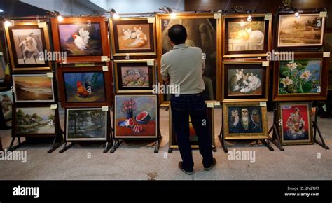 In This March Photo A Visitor Examines Paintings At The Public