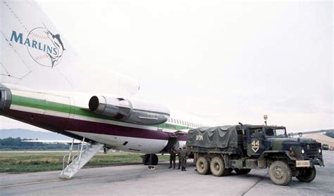 A Miami Airliner Is Loaded With Luggage By Soldiers From The 1st