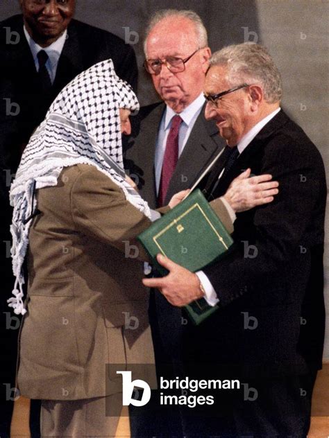 Image Of PLO Chairman Yasser Arafat Embraces Henry Kissinger After