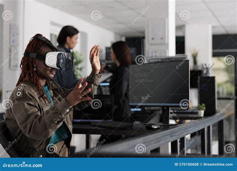 African American System Engineer Wearing Virtual Reality Goggles Stock