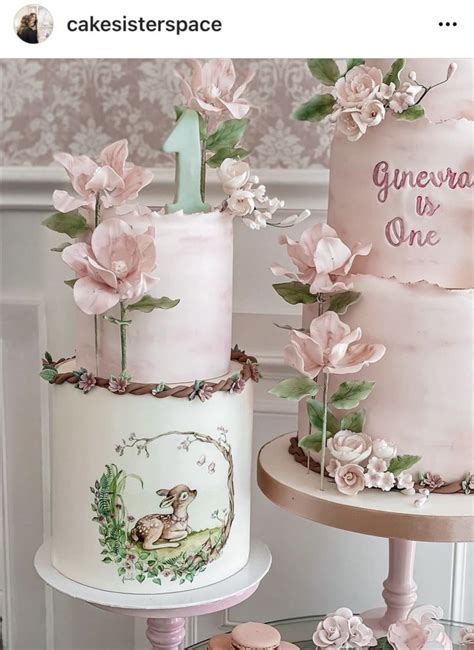 Three Tiered Cakes Decorated With Pink Flowers And Greenery