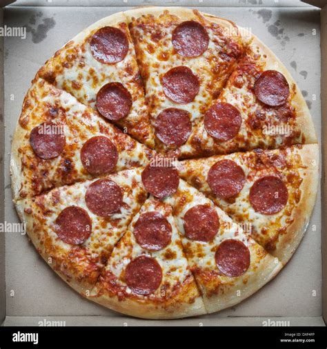 Overhead View Of Whole Pepperoni And Cheese Pizza In Cardboard Box