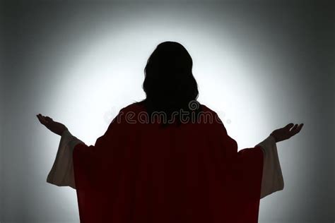 Silhouette Of Jesus Christ With Outstretched Arms On Color Background