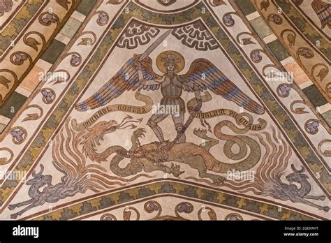 The Archangel Michael In Armor Lifts His Sword And Kills The Dragon