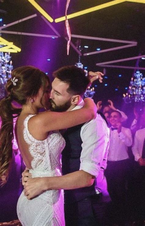 A Bride And Groom Dance Together In Front Of Their Guests At A Wedding