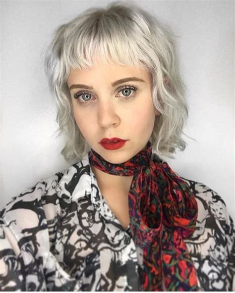 Icy Platinum Blonde Layered Bob With Messy Wavy Texture And Baby Fringe