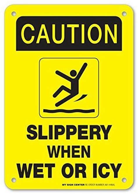 A Caution Sign That Says Slippery When Wet Or Icy