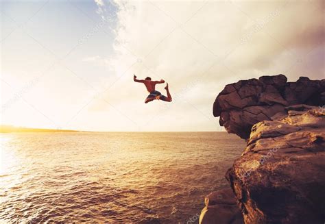 Cliff Jumping extreme at sunset Stock Photo by ©EpicStockMedia 91480078