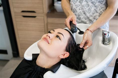 Beautiful Young Girl Enjoying Hair Washing In Hairdressing Salon Stock