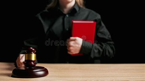 Female Sitting At The Desk With Wooden Hammer Dark Room Bright