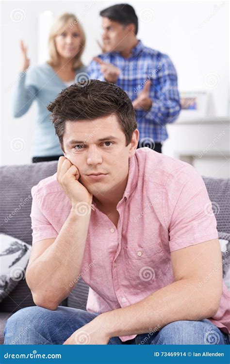 Mature Parents Frustrated With Adult Son Living At Home Stock Photo