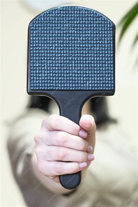 Premium Photo Close Up Of A Womans Hand Holding A Massage Device In Front Of Her Face Close Up