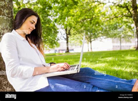 Beautiful Brunette Using Laptop In The Park Stock Photo Alamy