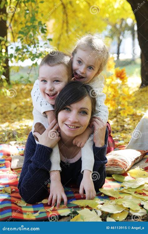 Mother And Two Children Lying Under Autumn Trees Stock Image Image Of