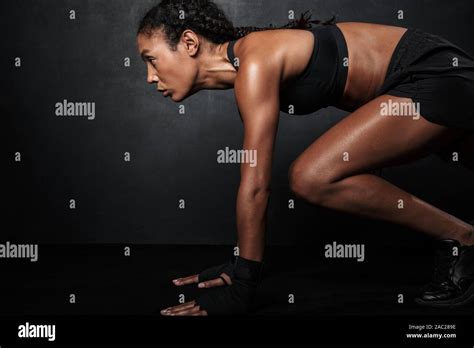 Image Of Muscular African American Woman In Sportswear Squatting While