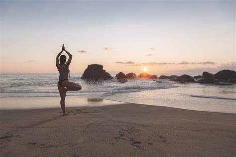 Young Attractive Latin Woman Wearing A Bikini Practicing Yoga On The