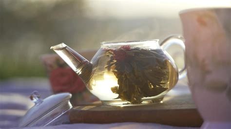 Premium Photo Hot Water Pours Into Full Tea Pot Outside In Nature On