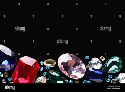 Different Beautiful Gemstones For Jewelry On Black Background Flat Lay