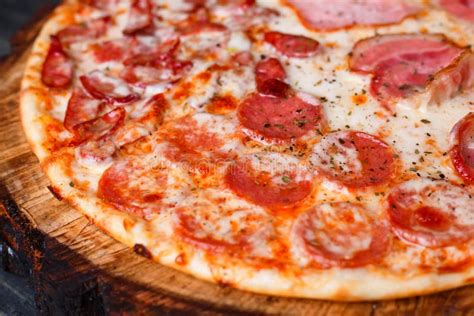 Delicious Yummy Fresh Pizza With Bacon Salami Ham And Pepperon Stock