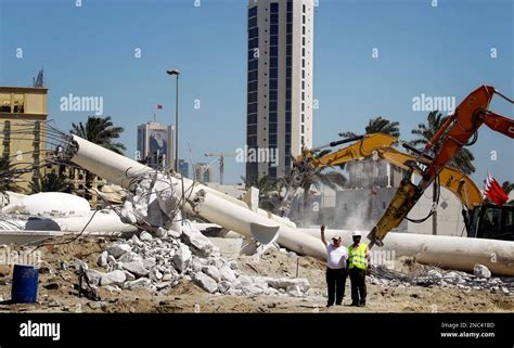 The Workers Seen Among The Debris Of The Pearl Square Statue In Manama