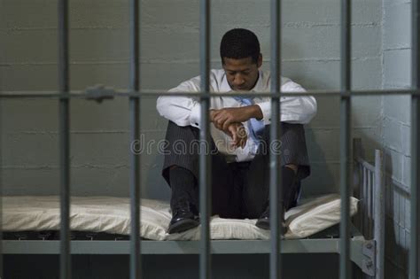 Man Sitting On Bed In Prison Cell Stock Photo Image Of Imprisoned