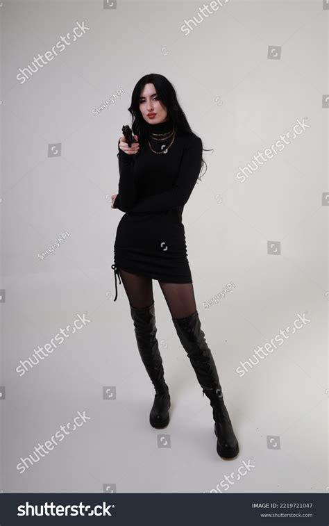 Beautiful Brunette Woman Aiming Pistol Stock Photo