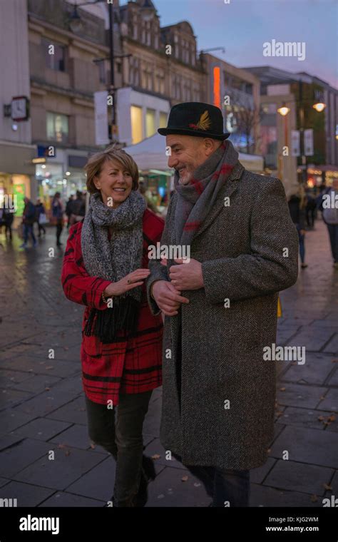 Mature Couple Are Enjoying Some Winter Shopping On An Evening At Christmas Time Stock Photo Alamy