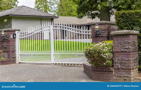 Iron Front Gate Of A Luxury Home Wrought Iron White Gate And Brick